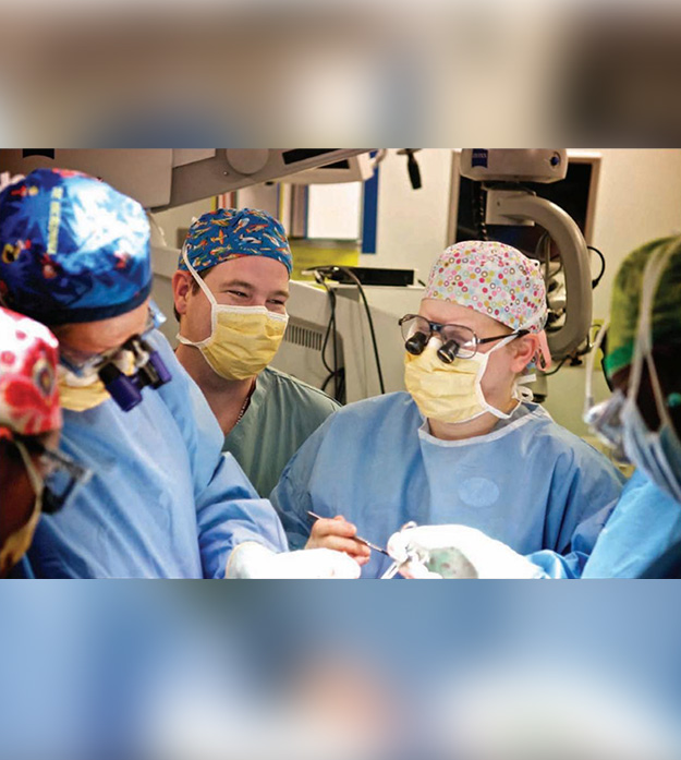 Dr. Edward J. Caterson and Dr. Stephanie Caterson performing facial reconstruction surgery