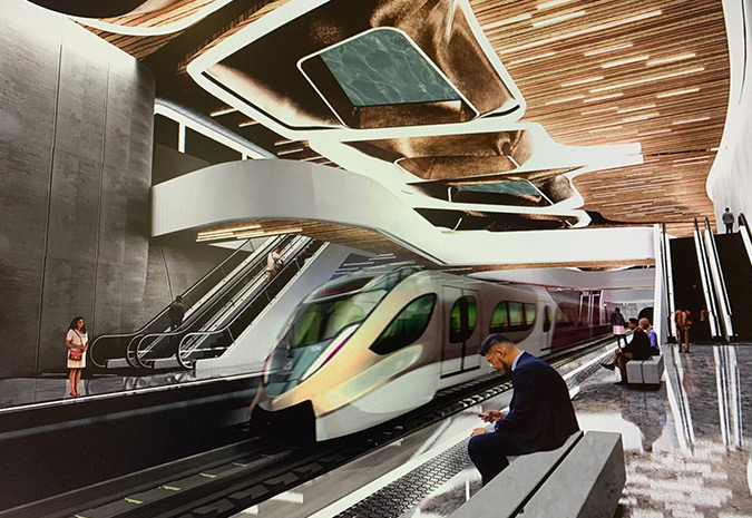 A rendering depicts a futuristic-looking transportation hub with pedestrians sitting and standing around the platform as a train approaches.