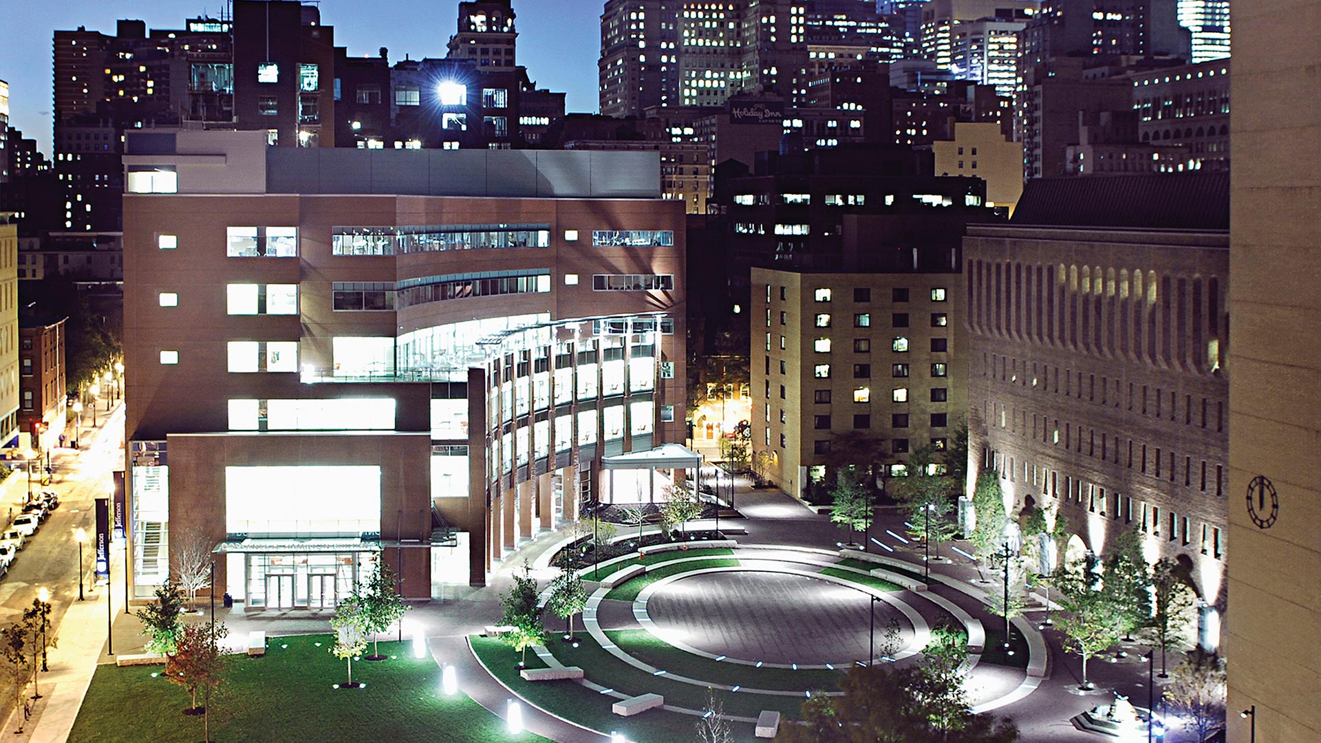 The Sidney Kimmel Medical College at Thomas Jefferson University at dusk with the Jefferson Center City Campus in the foreground.