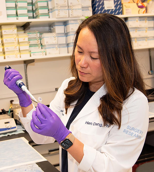 Dr. Hien Dang, a cancer researcher with the Sidney Kimmel Cancer Center — Jefferson Health, is working in a lab.
